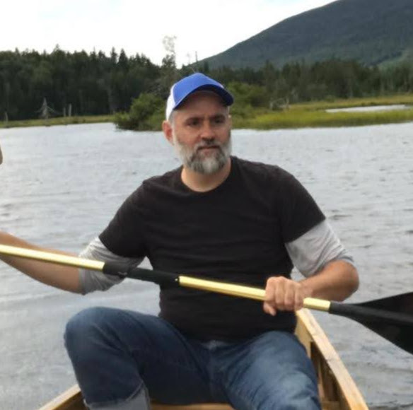 Jeremiah Hackett canoeing at Mooselookmeguntic